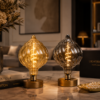 Unique Shape LED Filament Bulbs in Modern Interior Decorative Lighting Scene Unique shape LED filament bulbs in amber and smoke grey displayed in a modern interior setting for decorative ambient lighting